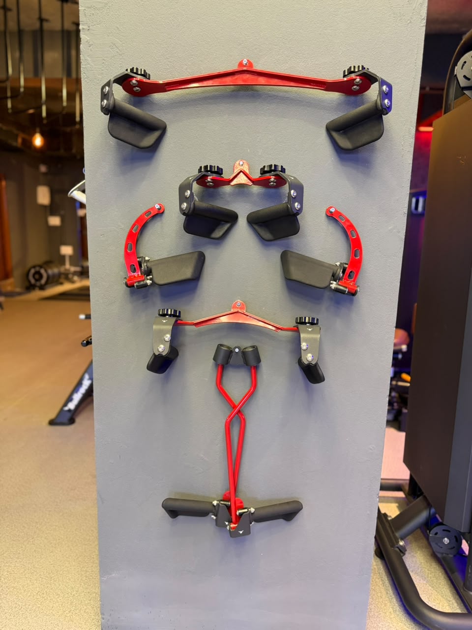 Cable machine attachments mounted on a pillar