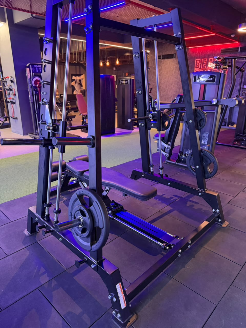 Shoulder press machine under hexagonal lighting